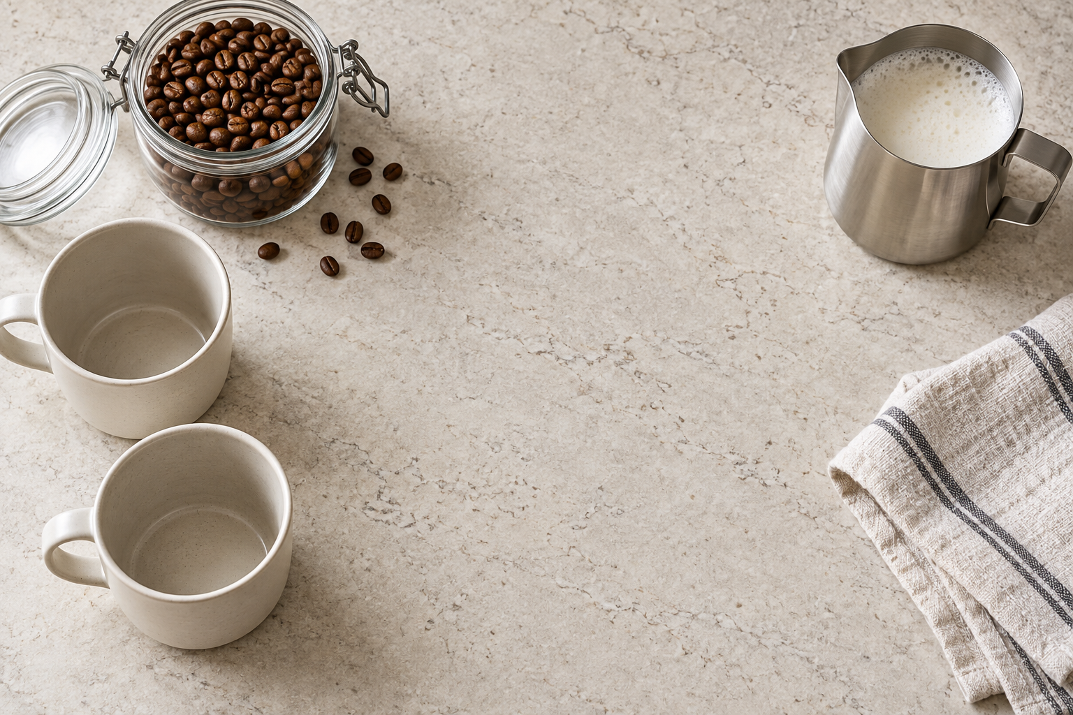 Coffee mugs, beans and milk jug arranged around an open preparation space.